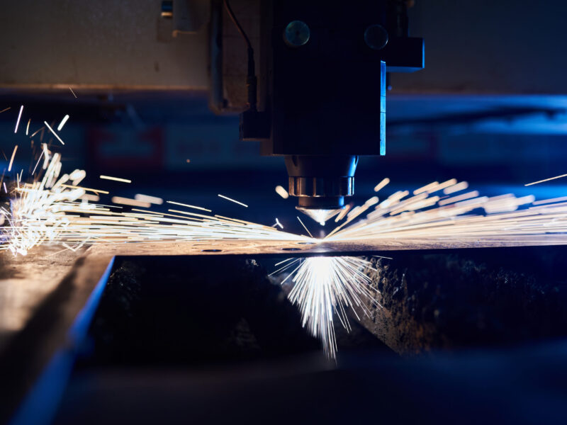 CNC Laser cutting of metal close up, modern industrial technology. Small depth of field.