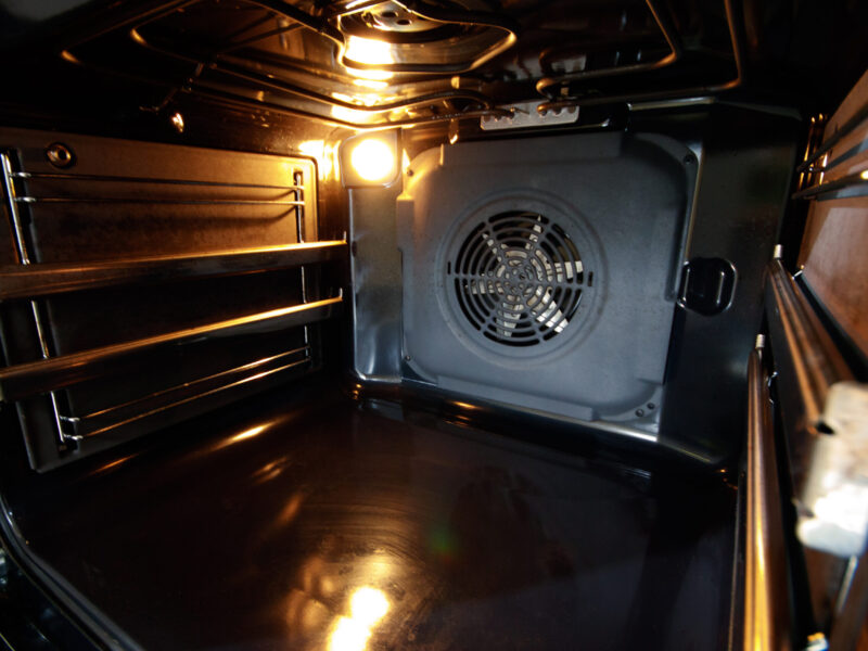 Oven interior with forced draft fan and lighting.